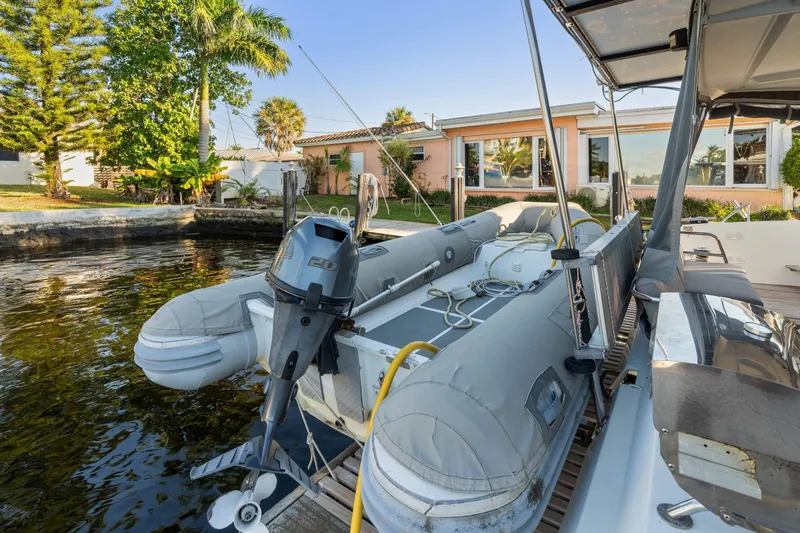 Grand Crew Yacht Photos Pics 2019 Fountaine Pajot 47 catamaran docked with inflatable boat and motor.