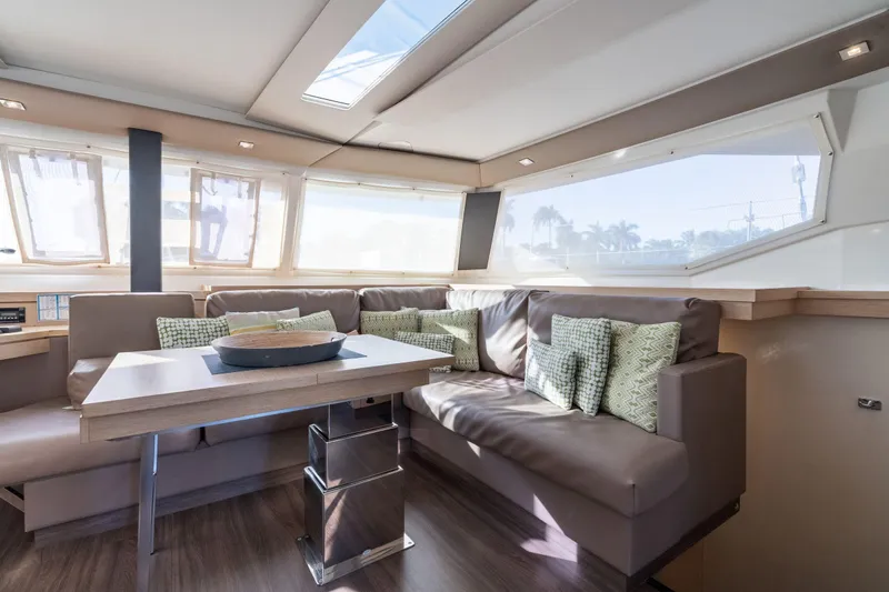 Grand Crew Yacht Photos Pics Luxurious interior of 2019 Fountaine Pajot 47 catamaran with modern seating and ample natural light.