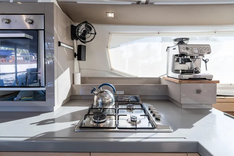 Grand Crew Yacht Photos Pics Modern kitchen in 2019 Fountaine Pajot 47 yacht with stove, oven, and espresso machine.