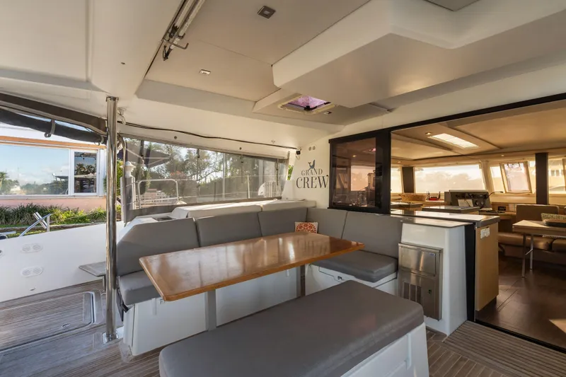 Grand Crew Yacht Photos Pics Luxurious interior of 2019 Fountaine Pajot 47 catamaran with spacious seating and dining area.