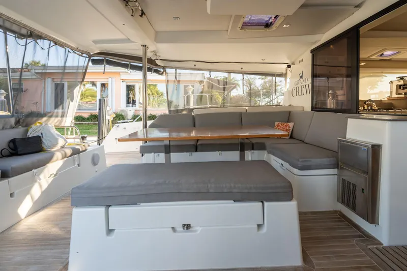 Grand Crew Yacht Photos Pics Spacious interior of 2019 Fountaine Pajot 47 catamaran with comfortable seating and dining area.