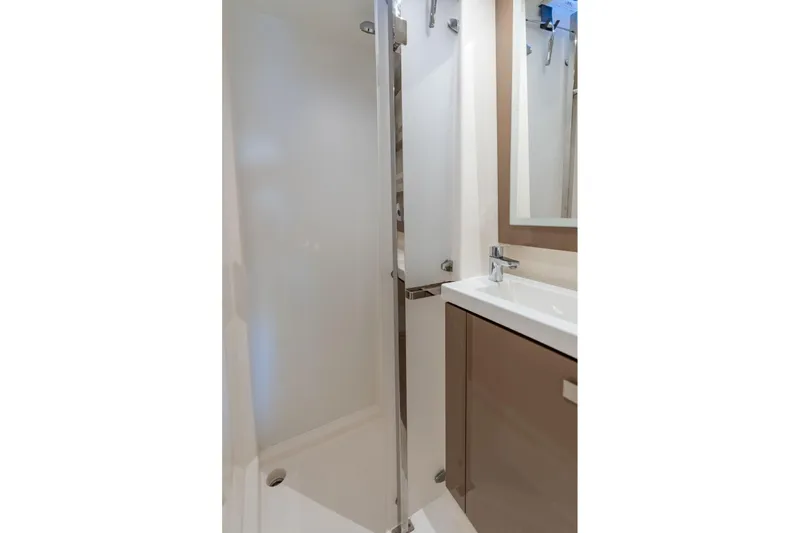 Grand Crew Yacht Photos Pics Modern bathroom interior on 2019 Fountaine Pajot 47 yacht, featuring sleek shower and sink.