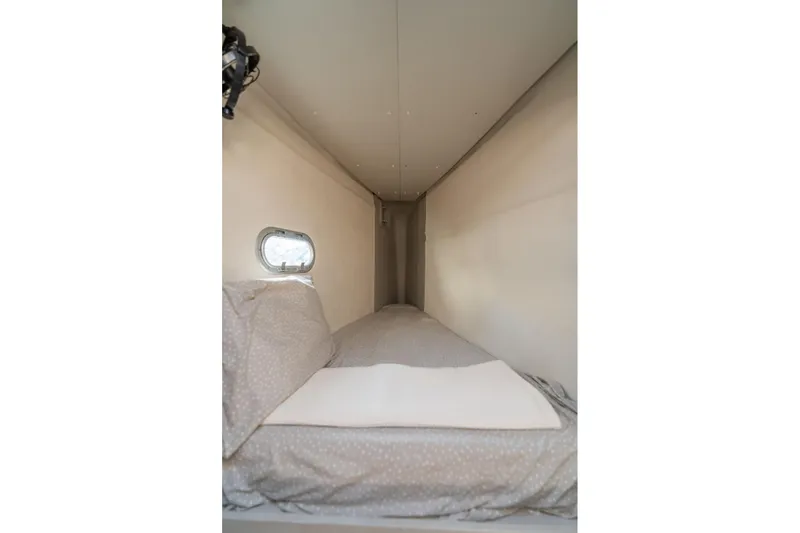 Grand Crew Yacht Photos Pics Cozy cabin bed in 2019 Fountaine Pajot 47 yacht with small window.