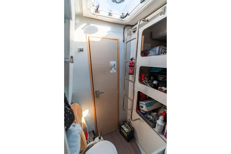 Grand Crew Yacht Photos Pics 2019 Fountaine Pajot 47 interior with storage shelves and a skylight.