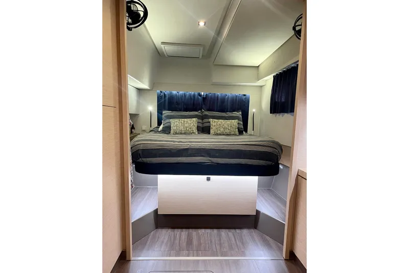 Grand Crew Yacht Photos Pics Luxurious bedroom interior of 2019 Saona 47 yacht with modern design and cozy bedding.