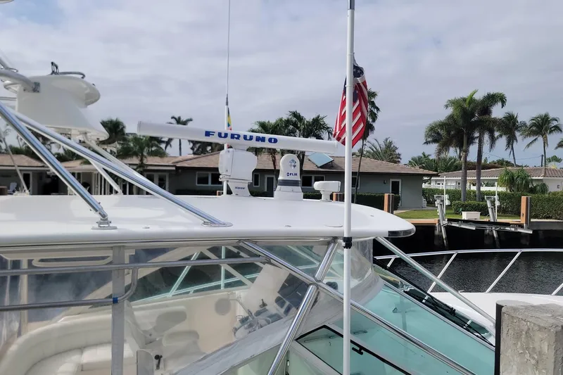 Miss Jayla Yacht Photos Pics 2004 Cabo 40 Express boat docked, featuring radar equipment and American flag.