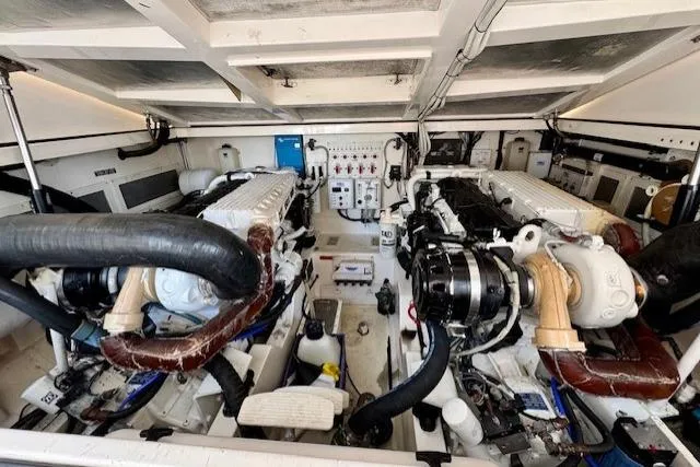 Miss Jayla Yacht Photos Pics Engine room of 2004 Cabo 40 Express with Seakeeper, showcasing dual engines and equipment.