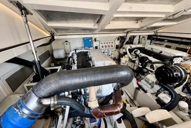 Miss Jayla Yacht Photos Pics Engine room of 2004 Cabo 40 Express with Seakeeper, showcasing mechanical components and systems.