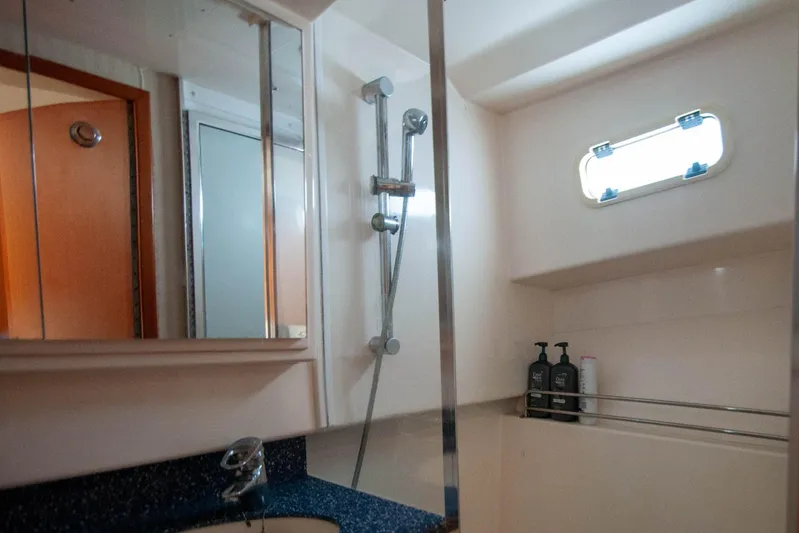 Miss Jayla Yacht Photos Pics Bathroom interior of 2004 Cabo 40 Express yacht with shower and window.