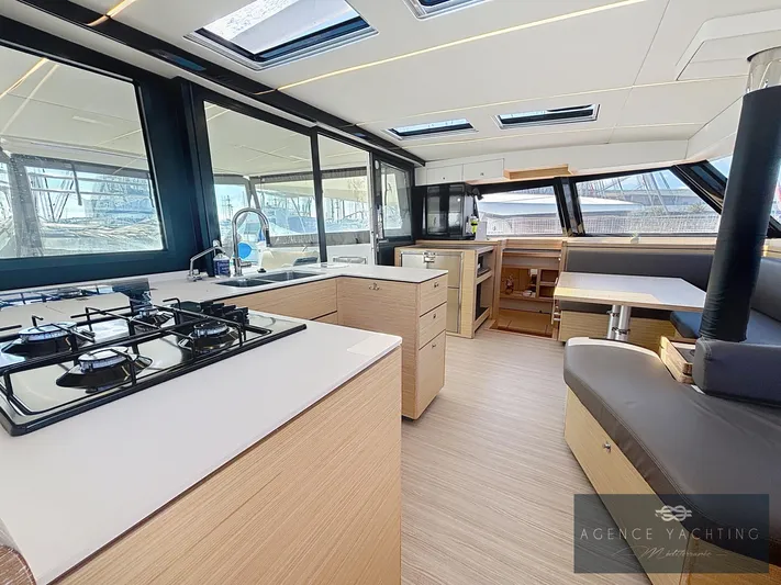 Kaija Yacht Photos Pics Modern interior of 2022 Nautitech 46 Open yacht with kitchen and seating area.