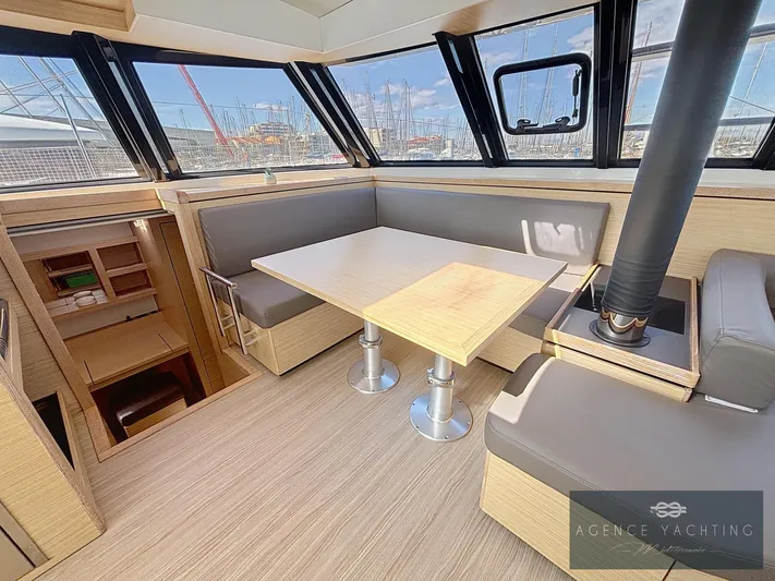 Kaija Yacht Photos Pics Modern interior of 2022 Nautitech 46 Open yacht with sleek dining area and panoramic windows.