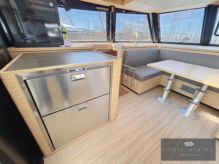 Kaija Yacht Photos Pics Modern interior of 2022 Nautitech 46 Open catamaran with sleek kitchen and dining area.