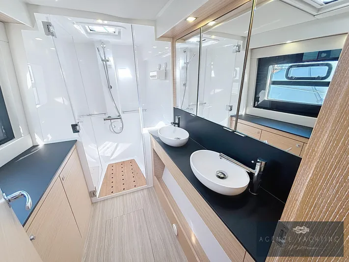 Kaija Yacht Photos Pics Luxurious bathroom in 2022 Nautitech 46 Open catamaran with dual sinks and modern shower.
