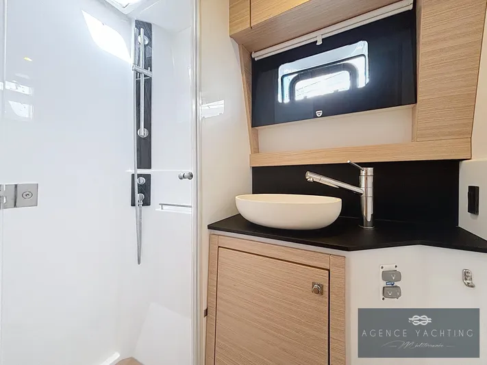 Kaija Yacht Photos Pics Modern bathroom in 2022 Nautitech 46 Open yacht with sleek fixtures and wood accents.