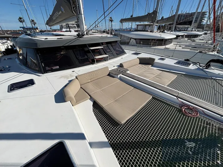 Kaija Yacht Photos Pics 2022 Nautitech 46 Open catamaran with sun loungers on deck, docked at marina.