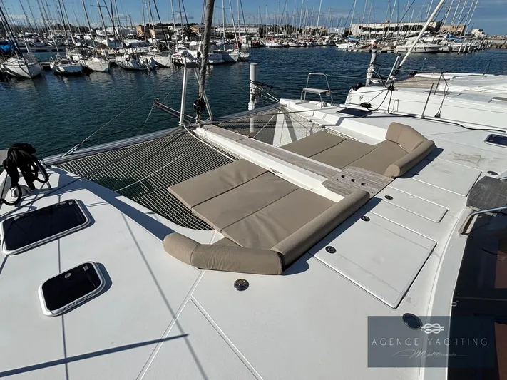 Kaija Yacht Photos Pics 2022 Nautitech 46 Open catamaran with spacious deck and comfortable seating in marina.