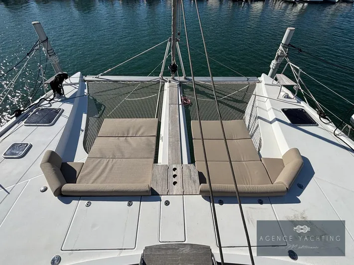 Kaija Yacht Photos Pics 2022 Nautitech 46 Open catamaran with sun loungers on deck, docked in a marina.
