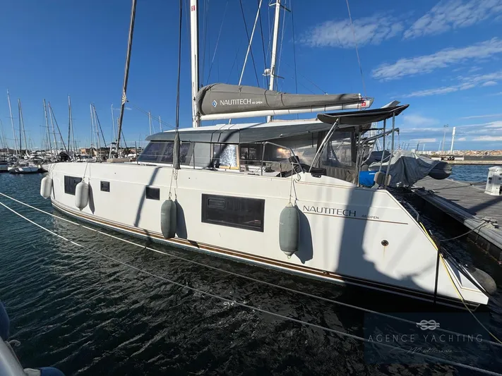 Kaija Yacht Photos Pics 2022 Nautitech 46 Open catamaran docked at marina under clear blue sky.