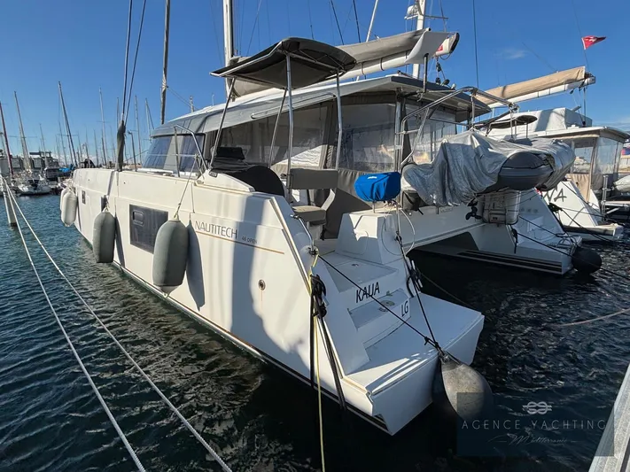 Kaija Yacht Photos Pics 2022 Nautitech 46 Open catamaran docked at marina, featuring sleek design and spacious deck.
