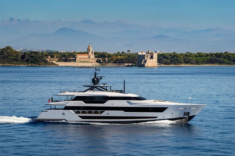  Yacht Photos Pics Luxurious 2022 Custom Line 140' yacht cruising near scenic coastline.