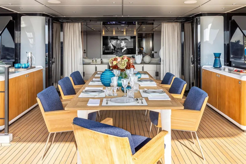  Yacht Photos Pics Luxurious dining area on 2022 Custom Line 140' yacht with elegant table setting.