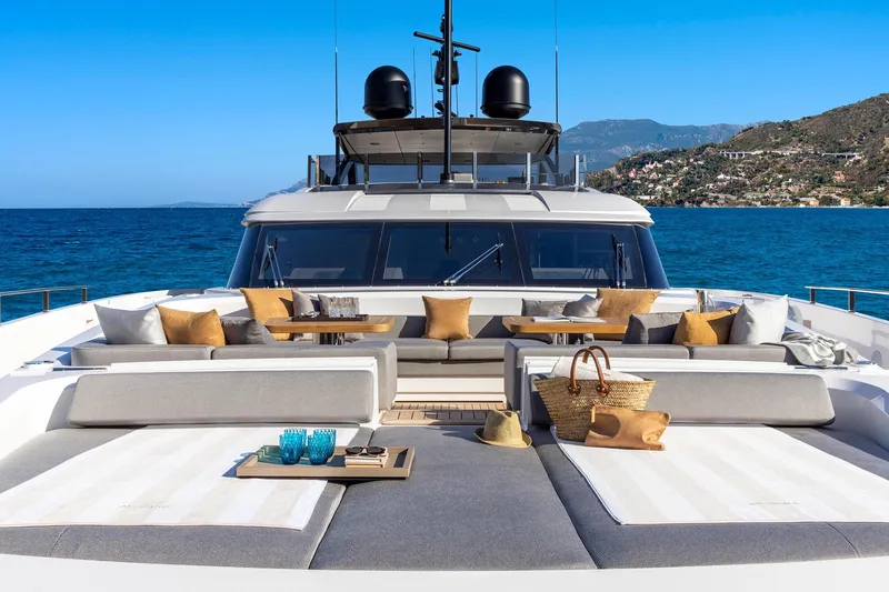  Yacht Photos Pics Luxurious 2022 Custom Line 140' yacht deck with elegant seating and ocean view.