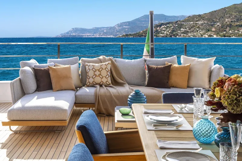  Yacht Photos Pics Luxurious yacht deck with elegant seating, dining setup, and ocean view, Custom Line 140', 2022.