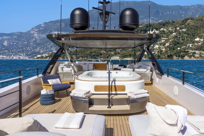 Yacht Photos Pics Luxurious 2022 Custom Line 140' yacht deck with jacuzzi and scenic ocean view.