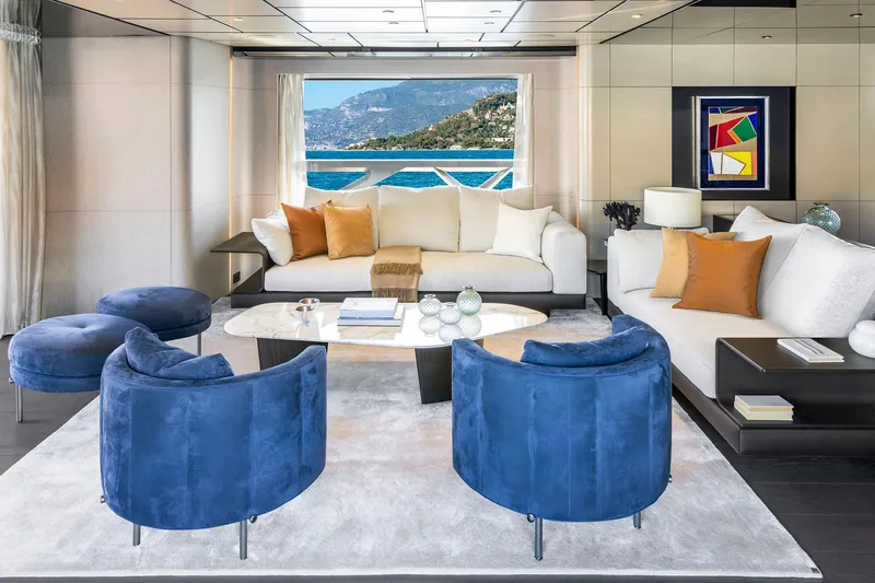  Yacht Photos Pics Luxurious yacht interior with blue chairs, white sofas, and ocean view, Custom Line 140', 2022.