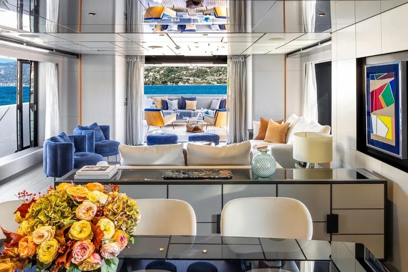  Yacht Photos Pics Luxurious yacht interior with modern decor, vibrant flowers, and ocean view, Custom Line 140', 2022.