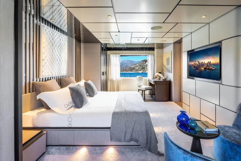  Yacht Photos Pics Luxurious yacht bedroom interior with ocean view, modern decor, and elegant furnishings, 2022 Custom Line 140'.