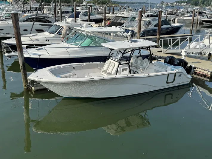 O4 Yacht Photos Pics 2022 Sea Fox 328 Commander boat docked in a marina with other vessels.