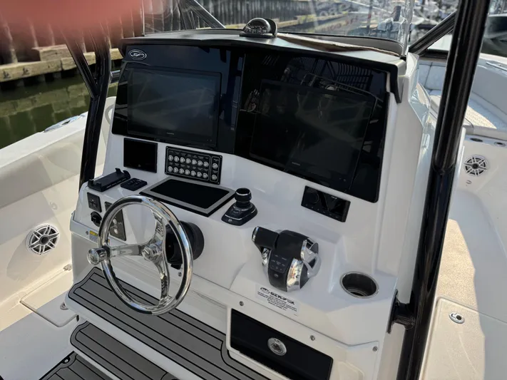 O4 Yacht Photos Pics 2022 Sea Fox 328 Commander boat dashboard with steering wheel and electronic controls.