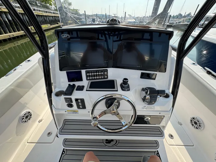 O4 Yacht Photos Pics 2022 Sea Fox 328 Commander boat dashboard with dual screens and steering wheel.
