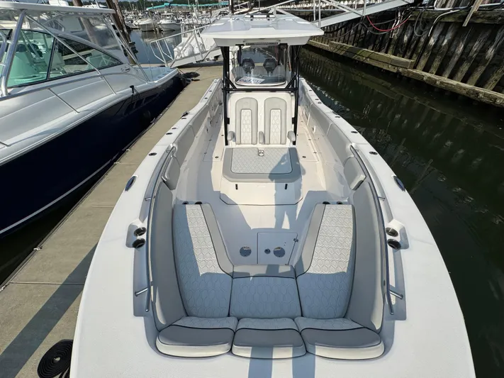 O4 Yacht Photos Pics 2022 Sea Fox 328 Commander boat docked, featuring spacious seating and sleek design.