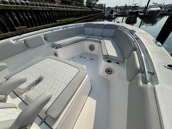 O4 Yacht Photos Pics 2022 Sea Fox 328 Commander boat interior with cushioned seating and speakers in a marina.