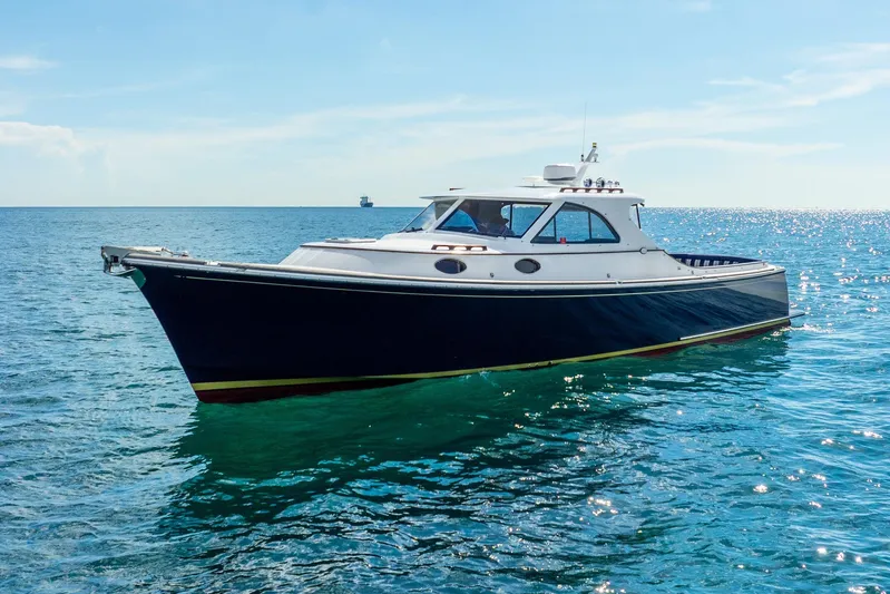 Volatility Yacht Photos Pics 2003 San Juan SJ 38 yacht on calm blue ocean waters.
