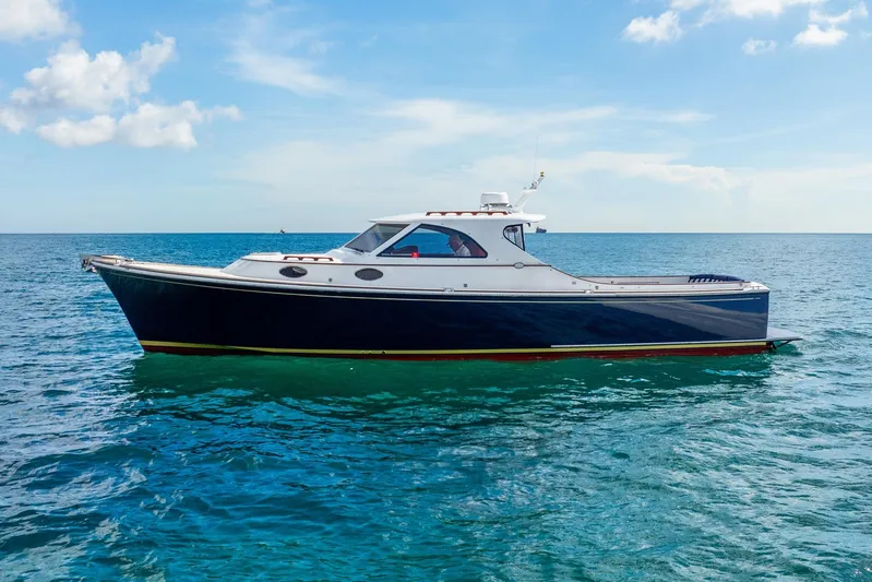 Volatility Yacht Photos Pics 2003 San Juan SJ 38 yacht on calm ocean under blue sky.