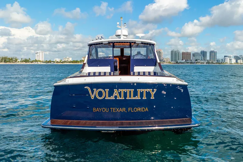 Volatility Yacht Photos Pics San Juan SJ 38 yacht "Volatility" on water, Bayou Texar, Florida, city skyline background.