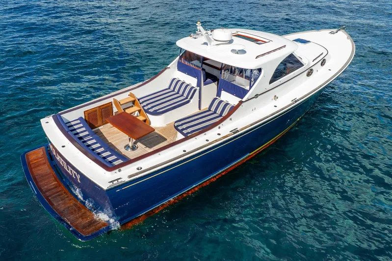 Volatility Yacht Photos Pics 2003 San Juan SJ 38 boat with striped seating on clear blue water.