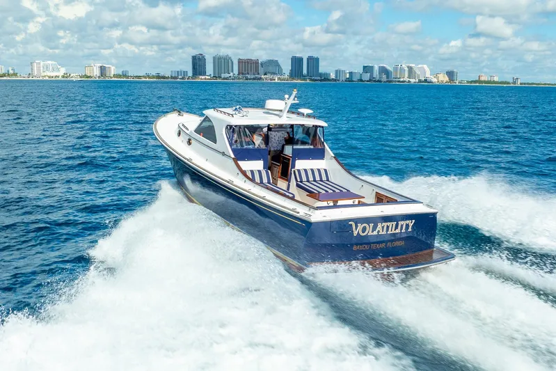 Volatility Yacht Photos Pics San Juan SJ 38 yacht cruising on blue ocean near city skyline, 2003 model.