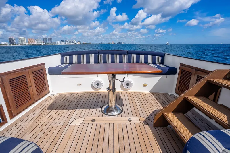 Volatility Yacht Photos Pics Luxurious San Juan SJ 38 yacht deck with seating, ocean view, and city skyline.