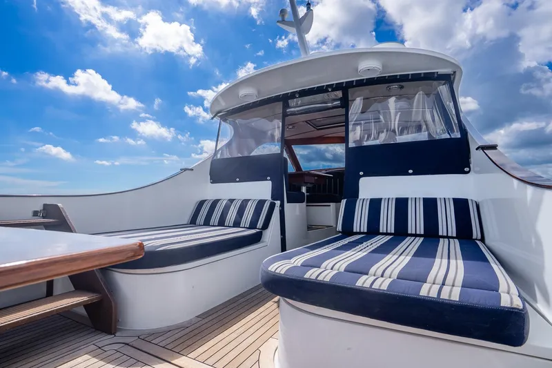 Volatility Yacht Photos Pics 2003 San Juan SJ 38 yacht deck with striped seating under a blue sky.
