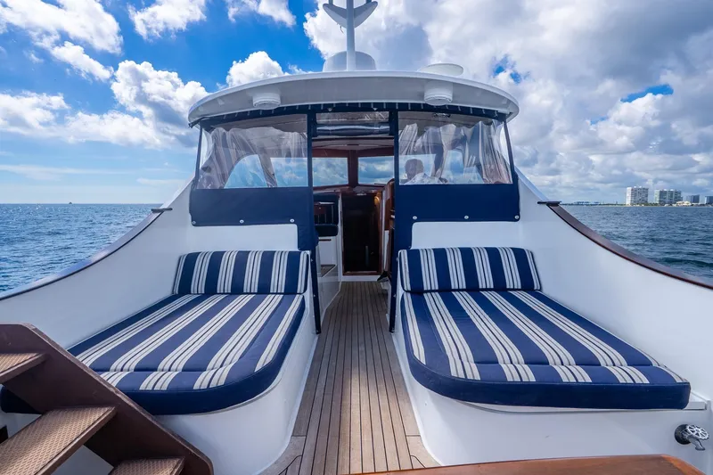 Volatility Yacht Photos Pics Luxury San Juan SJ 38 yacht deck with striped lounge chairs, ocean view, 2003 model.