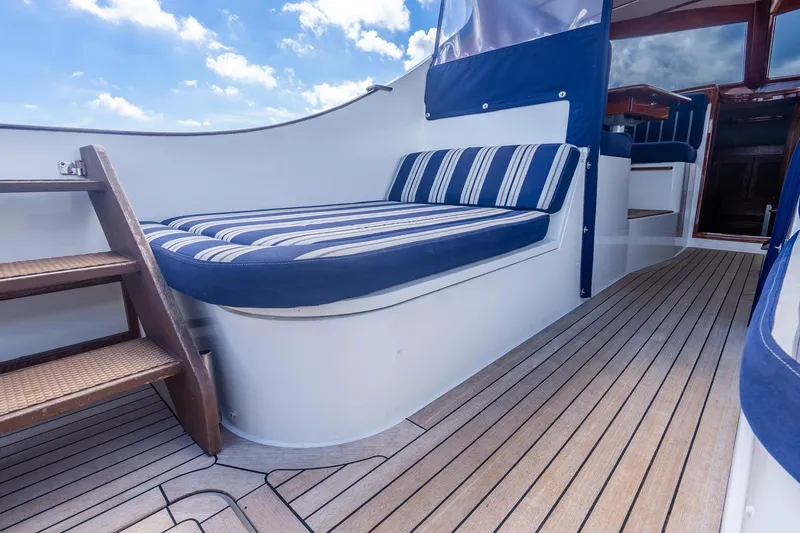 Volatility Yacht Photos Pics San Juan SJ 38 yacht interior with striped seating, wooden flooring, and stairs, 2003 model.