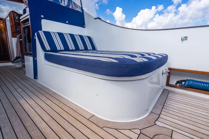 Volatility Yacht Photos Pics Luxury seating on San Juan SJ 38 yacht, 2003 model, with striped cushions and wooden deck.