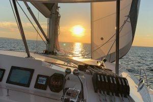2018 Leopard 40 sailing at sunset on open sea.