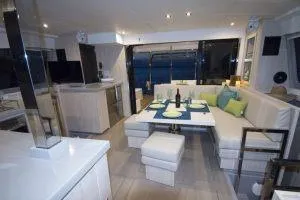 Isola Yacht Photos Pics Luxurious interior of 2018 Leopard 40 catamaran with elegant dining area and modern kitchen.