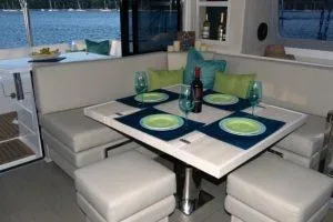 Isola Yacht Photos Pics Interior of 2018 Leopard 40 yacht with elegant dining setup and scenic water view.