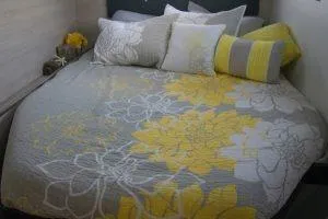 Isola Yacht Photos Pics Cozy bed with floral yellow and gray bedding in a 2018 Leopard 40 model.